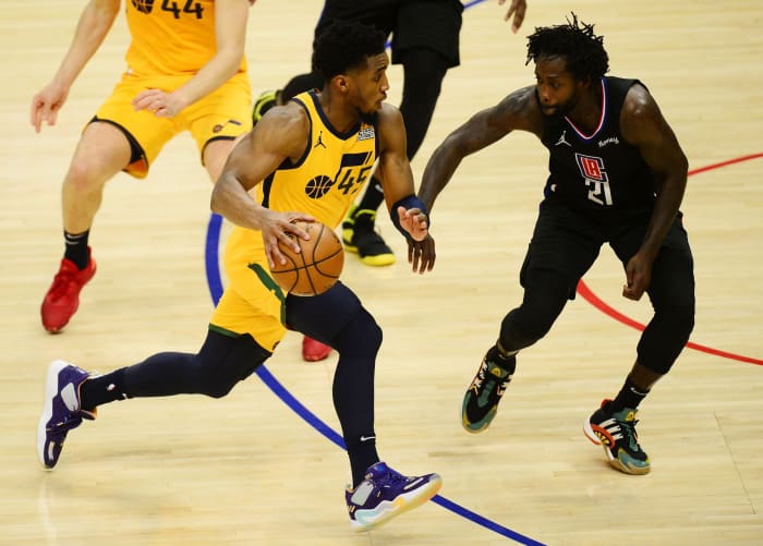 Donovan Mitchell (45) drives past Patrick Beverley (21)
